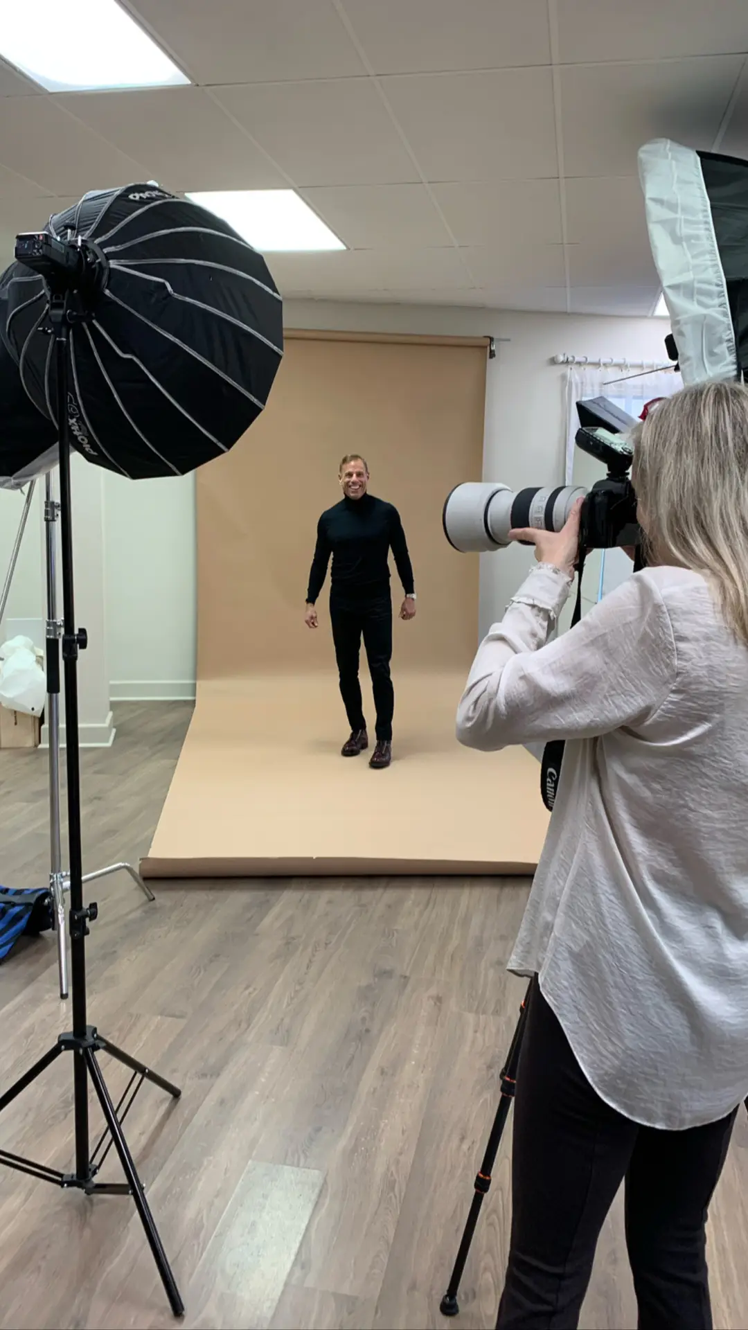 Paige Henderson photographing a client in the Bellus Photography headshot studio in Mandeville, Louisiana