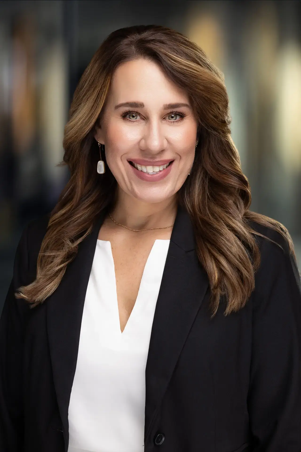 Executive headshot of a woman in a black blazer and white blouse by Bellus Photography